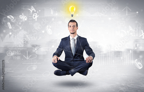 Businessman meditates with enlightenment data reports and financial concept 