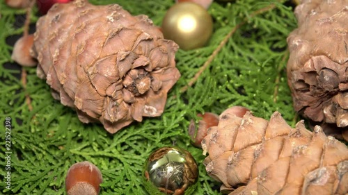 Pinecones and Baubles Rotationg on Fir Tree Branches. Cristmas Background photo