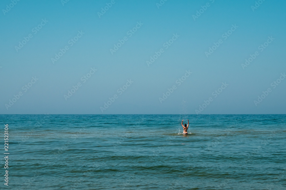 Young girl splashing in the water. Young girl splashing in the water.