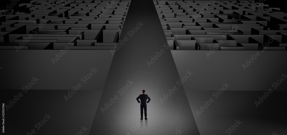 Businessman going straight ahead on a wide road between dark mazes
Businessman going straight ahead on a wide road between dark mazes