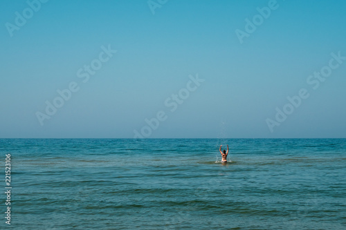 Young girl splashing in the water. © novolodskiy