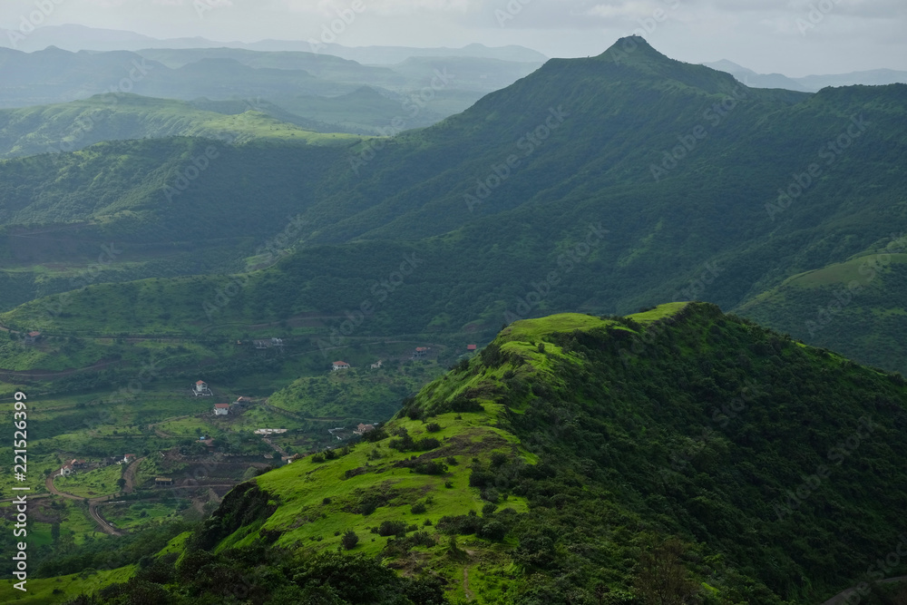 Naklejka premium Beautiful landscape aerial, and closeup Photos of nature, roads, grass, trees, village, and farm land. Lush green monsoon nature mountains, hills, Purandar fort, Pune, Maharashtra, India