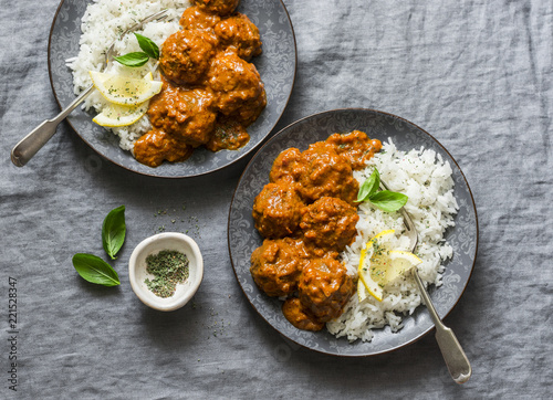 Lentils vegetarian roasted meatballs with curry sauce and rice - healthy lunch on grey background, top view. Flat lay