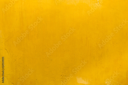 Background closeup textured bright yellow wall 