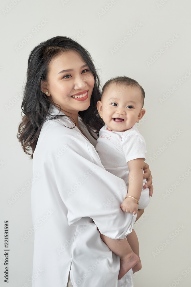 Happy loving family. Young smiling mother hugging laughing baby. Happy loving family. Young smiling mother hugging laughing baby.