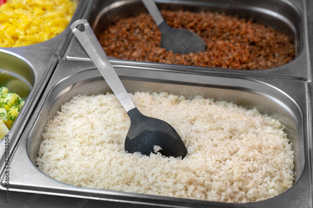 White boiled rice in metal container. Canteen, catering. White boiled rice in metal container. Canteen, catering.
