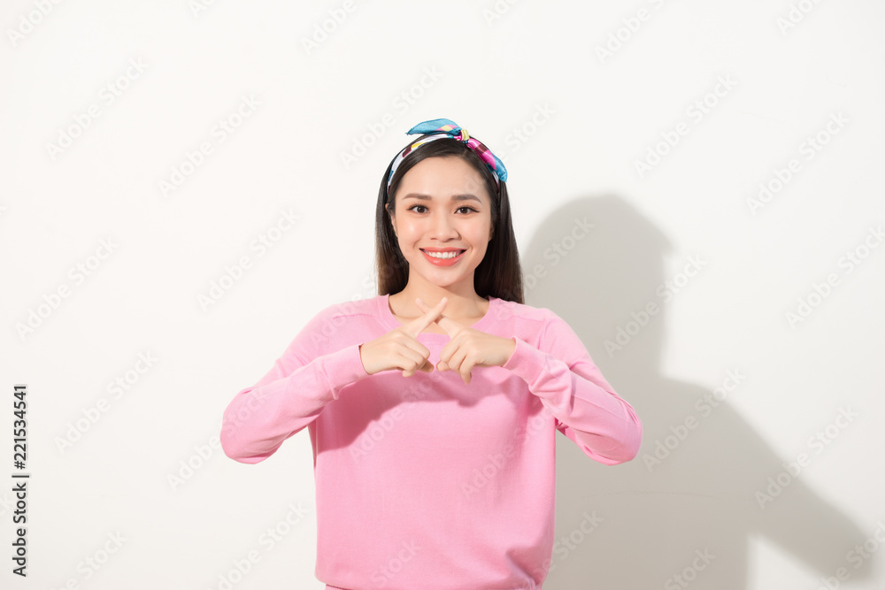 Pretty asian girl with fingers crossed to x shape, deny or forbidden sign, selected focus on hands Pretty asian girl with fingers crossed to x shape, deny or forbidden sign, selected focus on hands