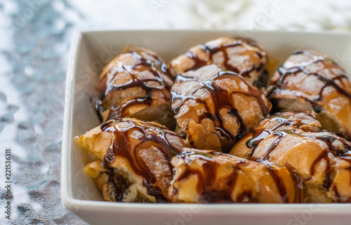 Chocolate and condensed sweet milk crunchy toast cut into pieces on white square bowl