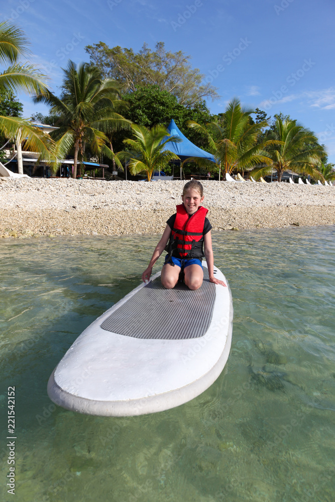 Φωτογραφία Girl on paddle board on a tropical island in Vanuatu an island paradise located in the South Pacific