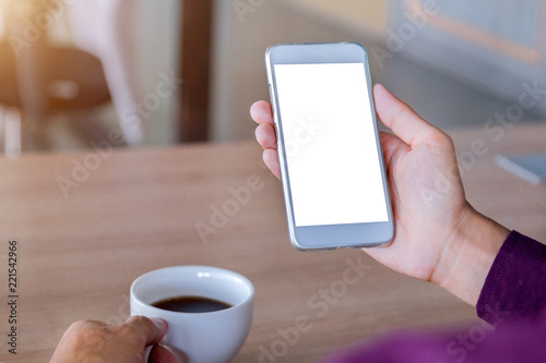 Mockup image of man's hands holding white mobile phone with blank screen technology and lifestyle concept.