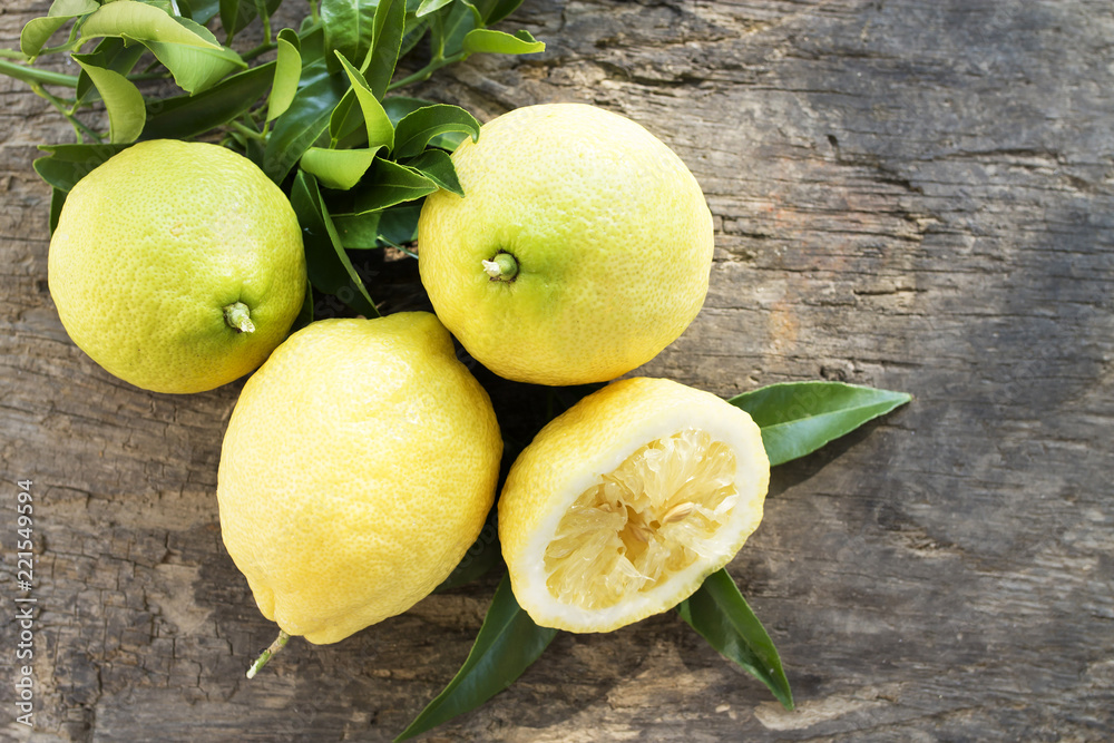 lemons with leaves on background