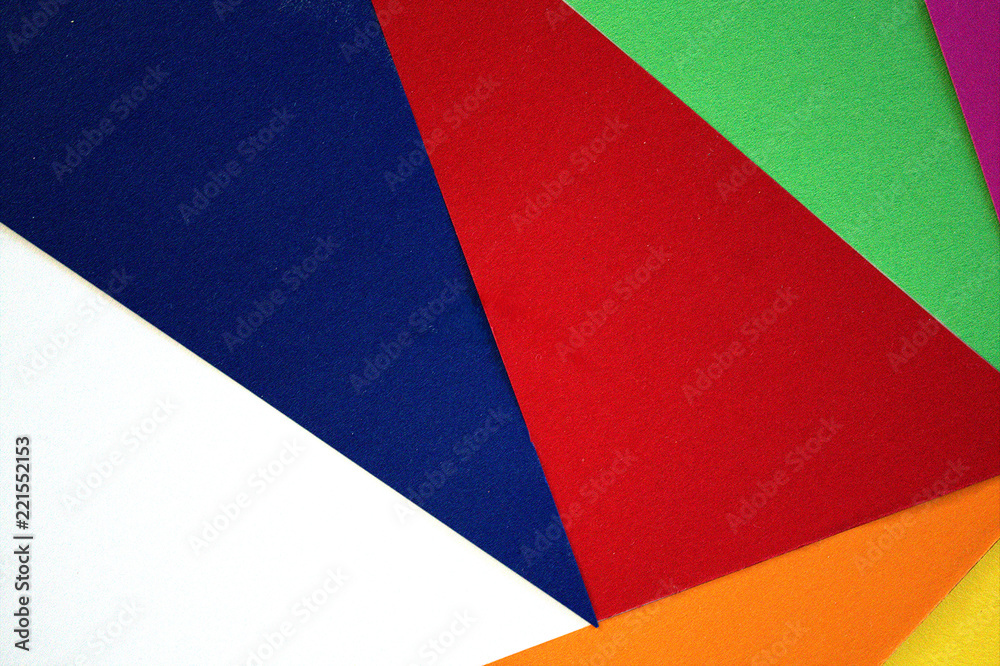 The cut colored paper lies on the table. The cut colored paper lies on the table.
