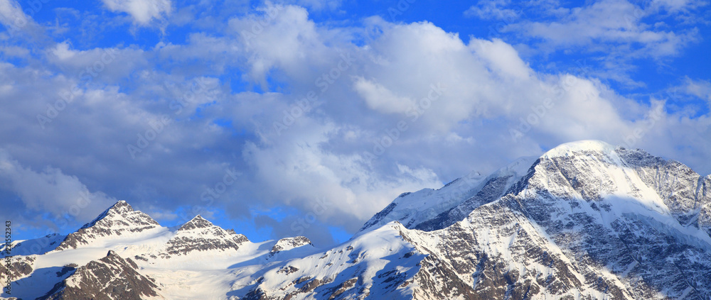 snow-covered peaks and clouds