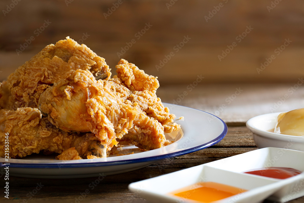 Fried chicken in white dish with souce and mash potato on wooden table Fried chicken in white dish with souce and mash potato on wooden table
