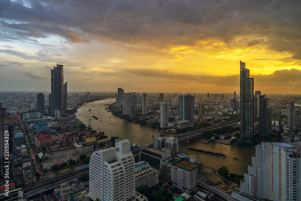 aerial view of sunset cityscape with curve of river