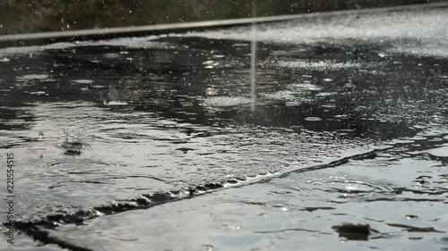 Closeup view on the raindrops on the concrete during a heavy rain scene.
