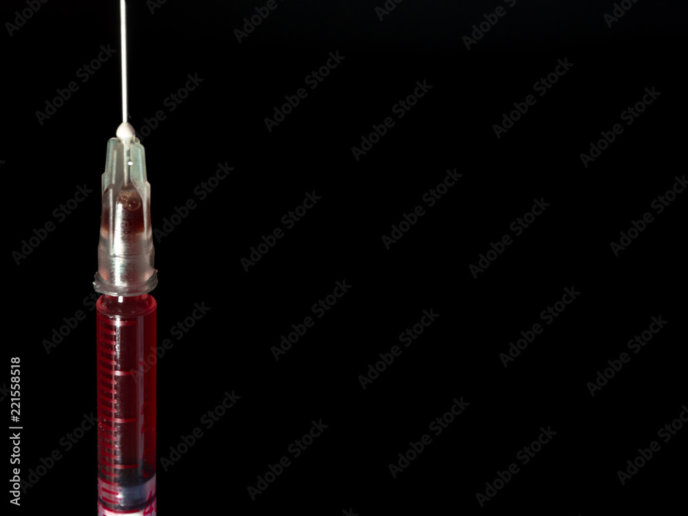 Syringe, injection needle on black background Syringe, injection needle on black background