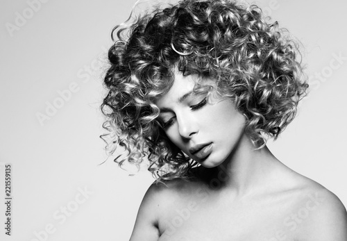 Beauty portrait of young woman with eyes closed. Beautiful hairstyle with curly hair. Professional make-up, delicate clean skin