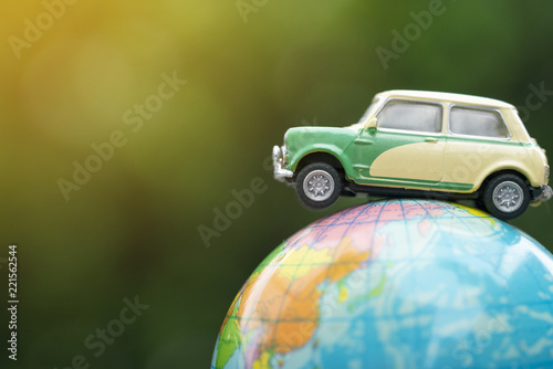 Travel and transport concept, car on world map balloon with green nature background. photo