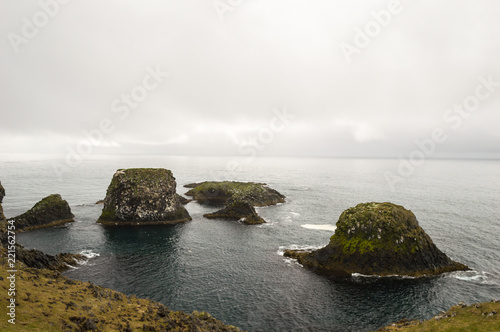 Cliffs washed by waves near Gatklettur arch rock in Snaefellsnekull, Iceland