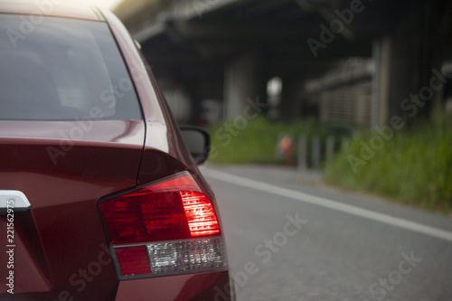 Car break on the road in traffic junction at evening. Next to the bridge across the different levels.