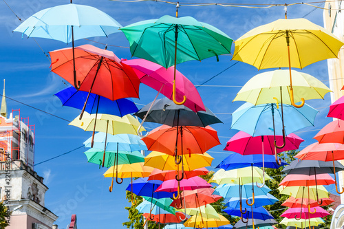 Wallpaper Mural Different colorful umbrellas hanging over the street against sky Torontodigital.ca