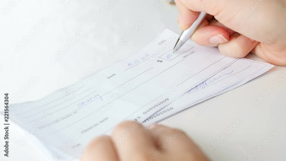 Closeup 4k video of young woman signing 1000 dollars bank cheque with pen