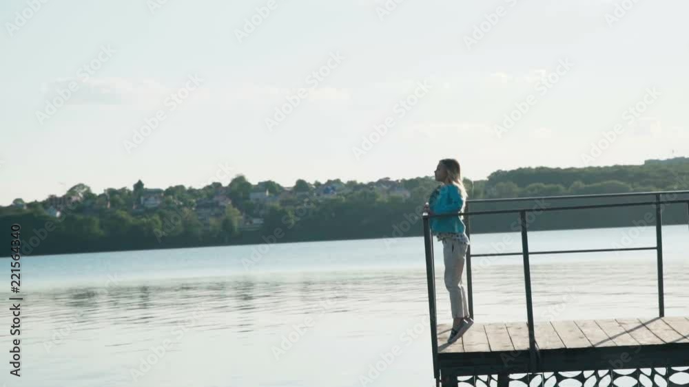 Little blonde running on the quay under bright sky at pond Little blonde running on the quay under bright sky at pond