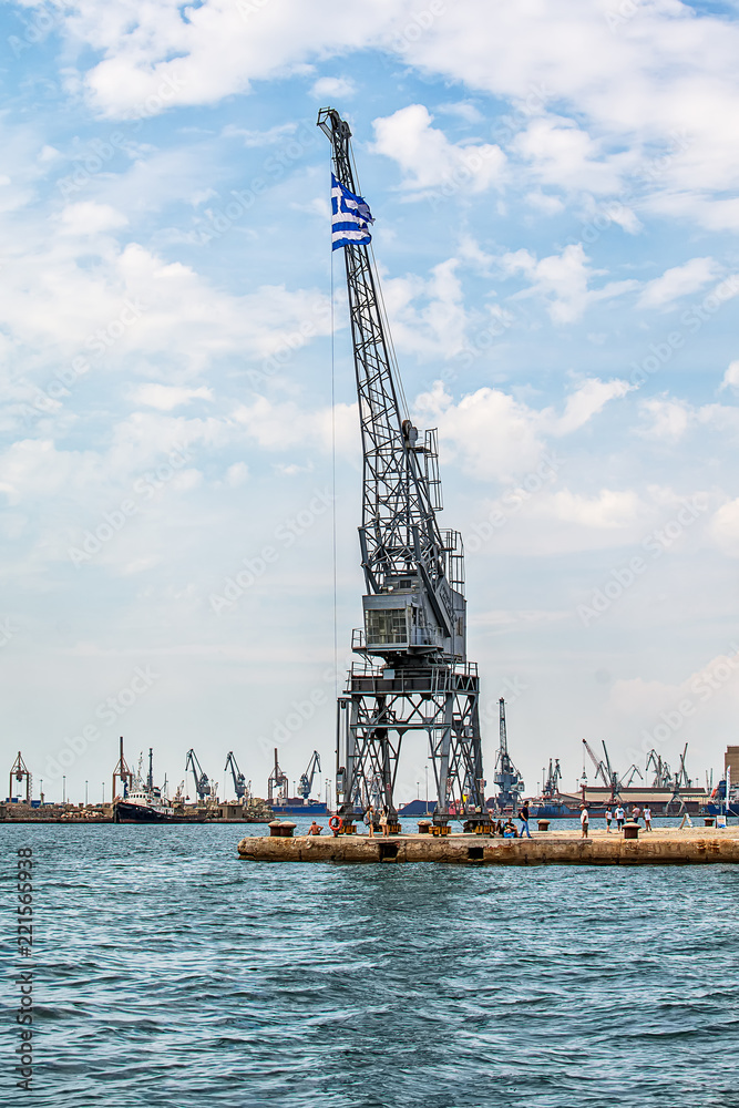 Thessaloniki, Greece - August 16, 2018: Coast of historical cityview with traditional winches at harbour of Thessaloniki, Greece Thessaloniki, Greece - August 16, 2018: Coast of historical cityview with traditional winches at harbour of Thessaloniki, Greece