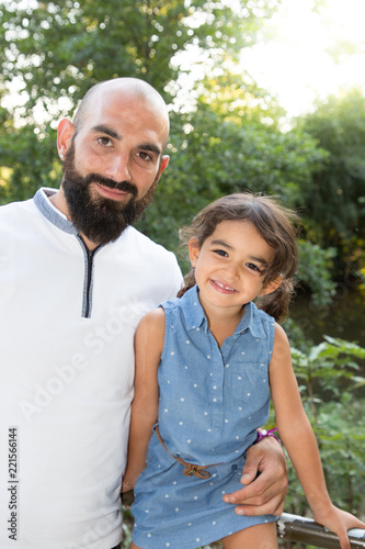 handsome father with cute girl daughter in park