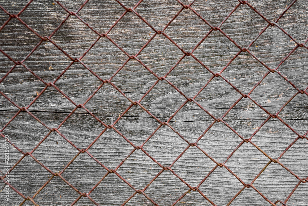 Fototapeta premium Wooden surface with metal mesh