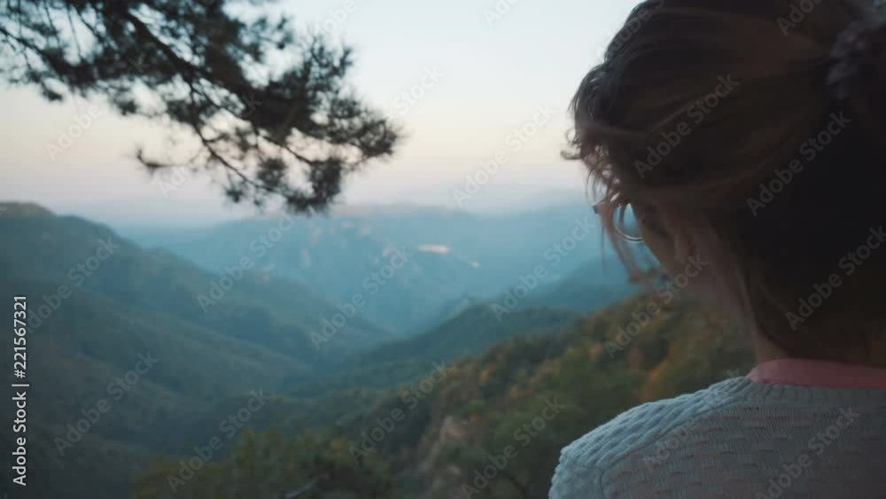 The girl looks at the mountains The girl looks at the mountains