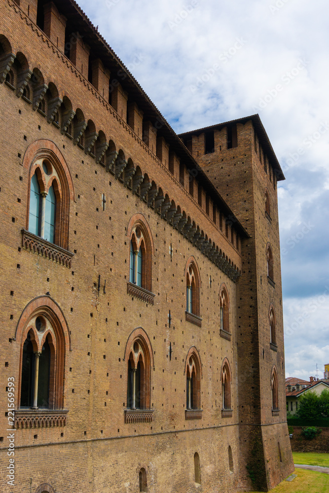 Fototapeta premium The facade of the Visconti Castle ( castello visconteo ). Medieval building with red brick facades in Pavia, Lombardy, Italy