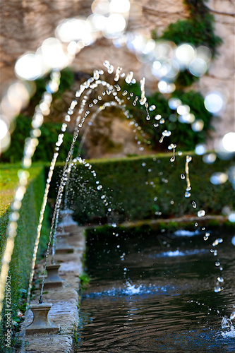 Arabic style water game fountain in palace garden in Granada Spain © oliverouge