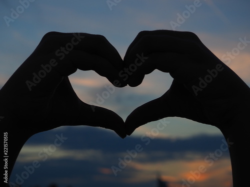 Heart shape of hands against beautiful sky - evening  night