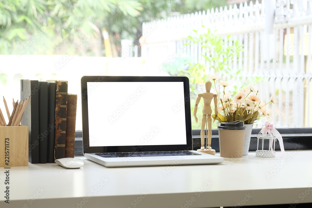 Mockup laptop computer and office supply on workspace with home office and big window.