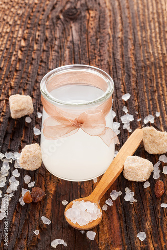 Tibi crystals in water in glass jar. photo