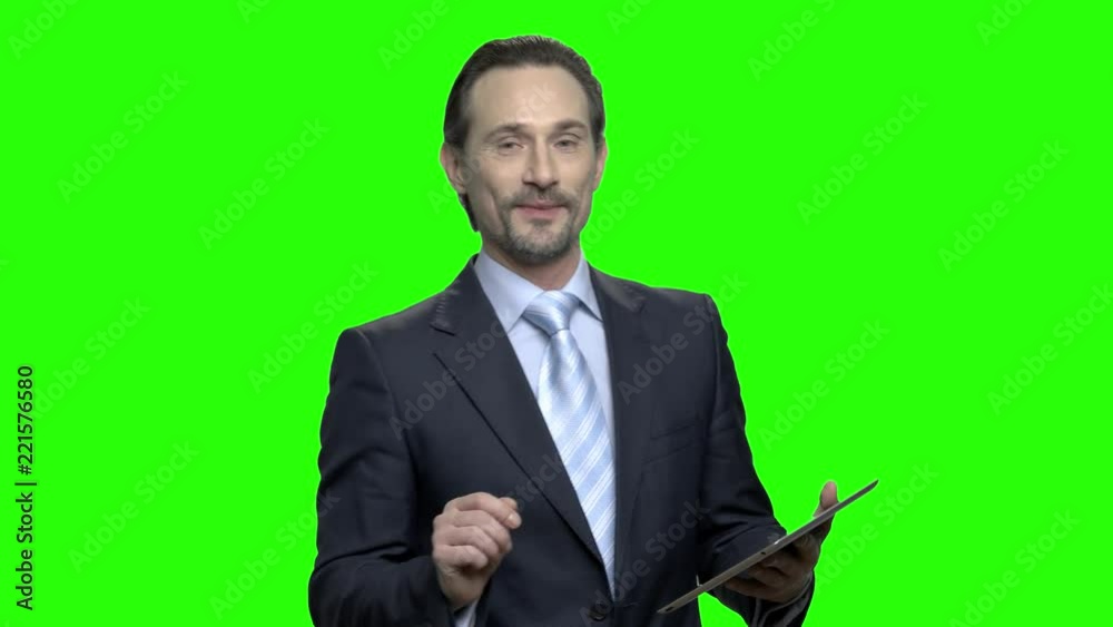 Executive business coach in suit. Portrait of mature caucasian man with tablet. Green hromakey background for keying. Executive business coach in suit. Portrait of mature caucasian man with tablet. Green hromakey background for keying.