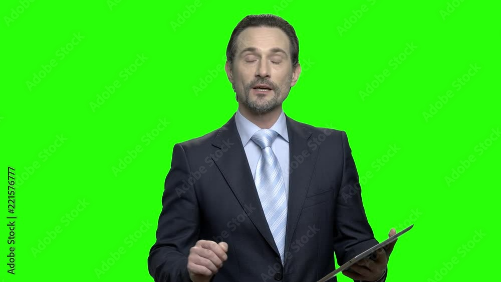 Presentable business speaker poritrait. Mature middle-aged handsome man in suit. Green hromakey background for keying.