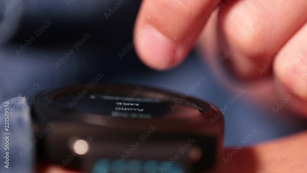 Close-up view of white kid's hand with black smartwatch. Child learning to use his new modern gadget with touch screen. Shallow depth of field. Real time full hd video footage.