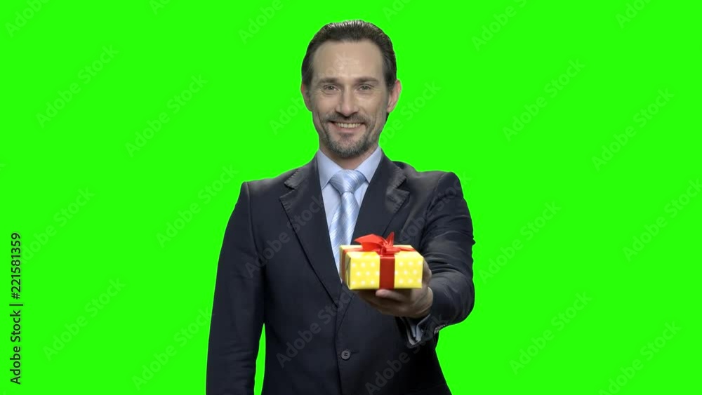Portrait of smiling cheerful man giving you a present. Green hromakey background for keying. Portrait of smiling cheerful man giving you a present. Green hromakey background for keying.