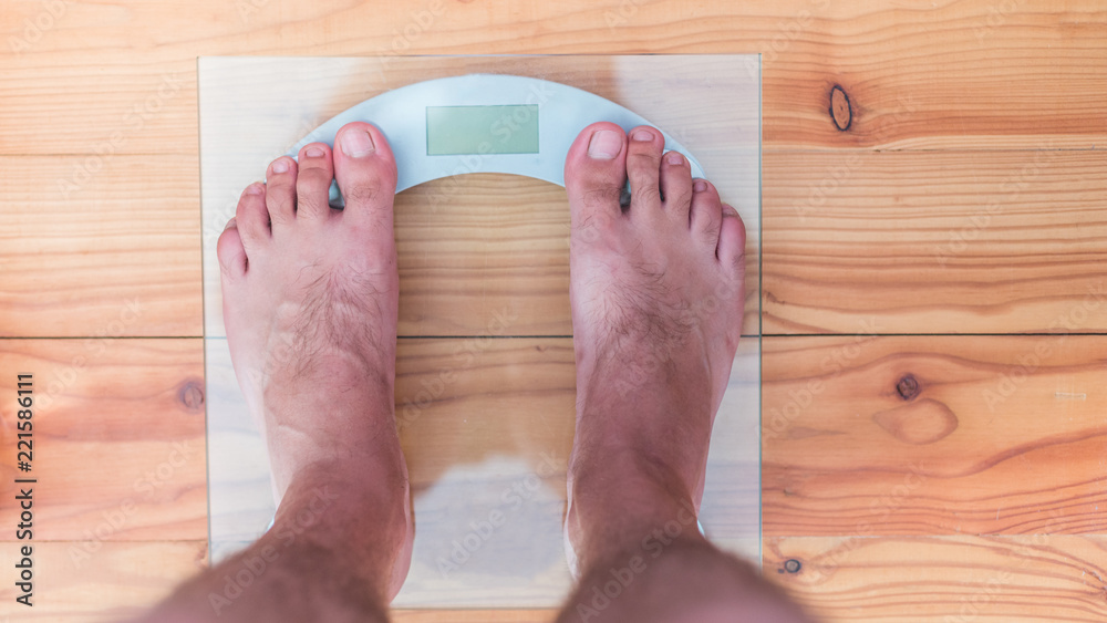 Man's feet on weight scale - Time for gym Stock Photo by ©michaklootwijk  159795848