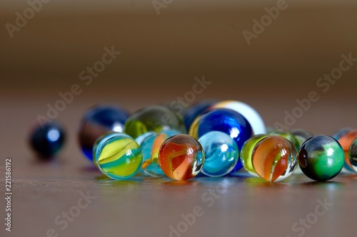 glass Marbles on dark wooden floor