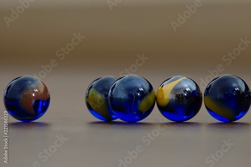 glass Marbles on dark wooden floor