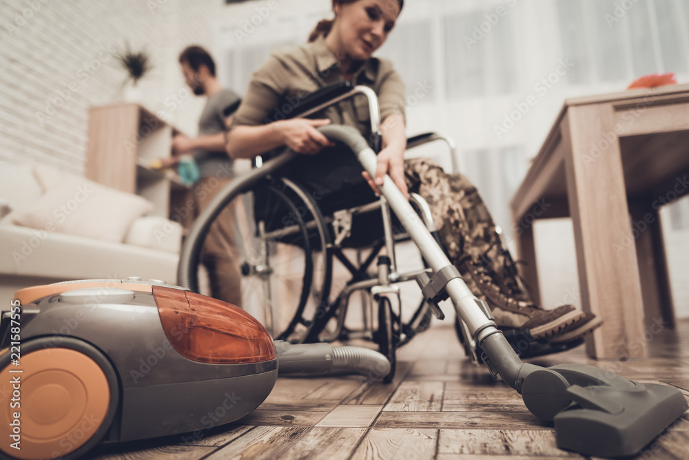 Obraz premium Female Veteran In A Wheelchair Is Cleaning House.