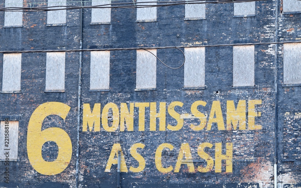 Obraz premium 6 months same as cash sign wording on old brick building