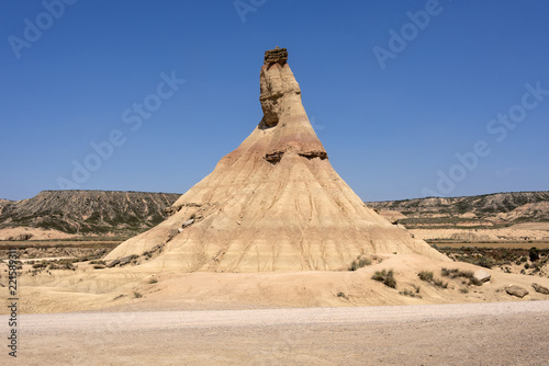 Spain, Bardenas Reales: Famous touristic hot spot called Castil de Tierra in the Spanish natural semi desert sierra national park with rocky mountain chain, wide plains and blue sky in the background.