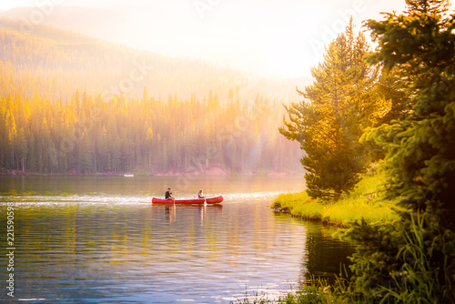 Fototapeta Naklejka Na Ścianę i Meble -  couple in a canoe on a mountain lake during autumn.