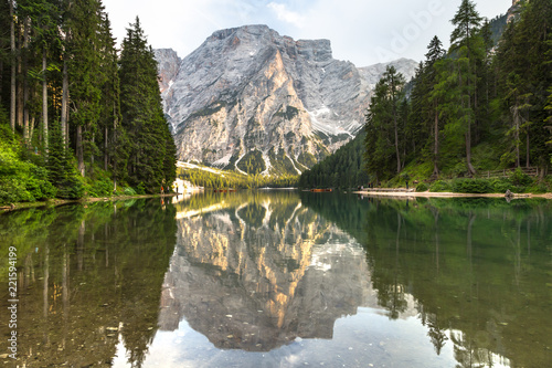 Lake braies also known as Lago di Braies. The most beautiful lake in Dolomites and Alps. A huge mountain reflecting in the water before sunset. National park Fanes Sennes Braies, South Tyrol, Italy. 