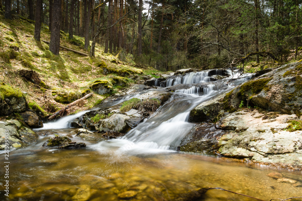 Beautiful waterfall in a forest in Canencia Madrid Beautiful waterfall in a forest in Canencia Madrid